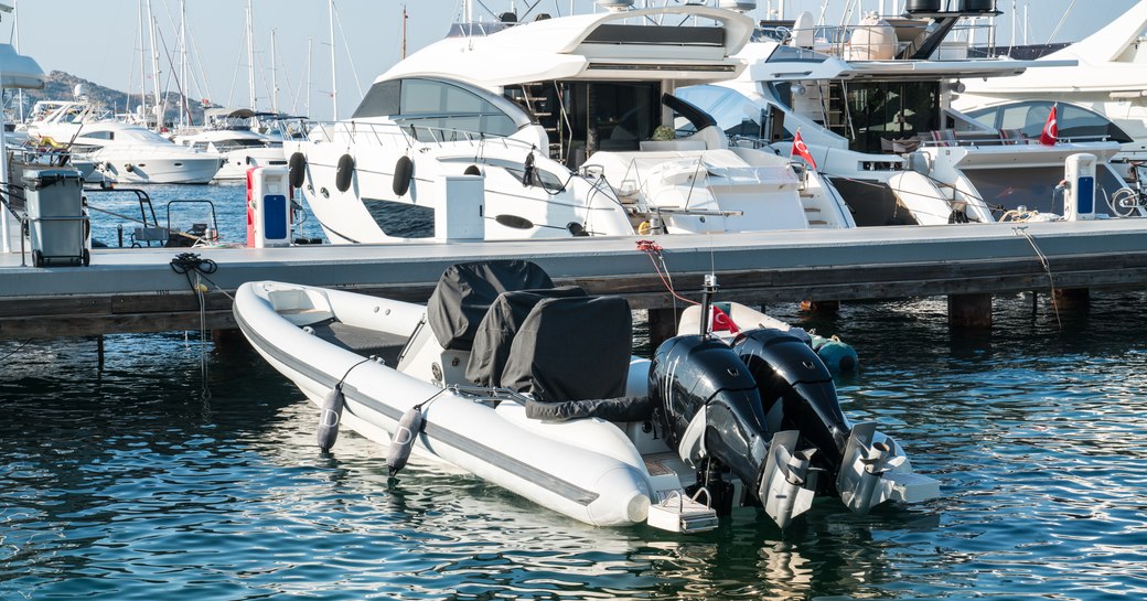 Motor yachts and RIB moored at Yalikavak Marina