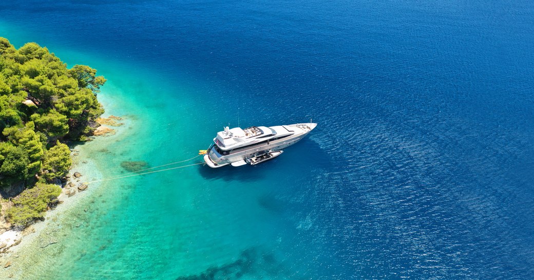 Luxury yacht charter anchored down in crystal clear blue waters