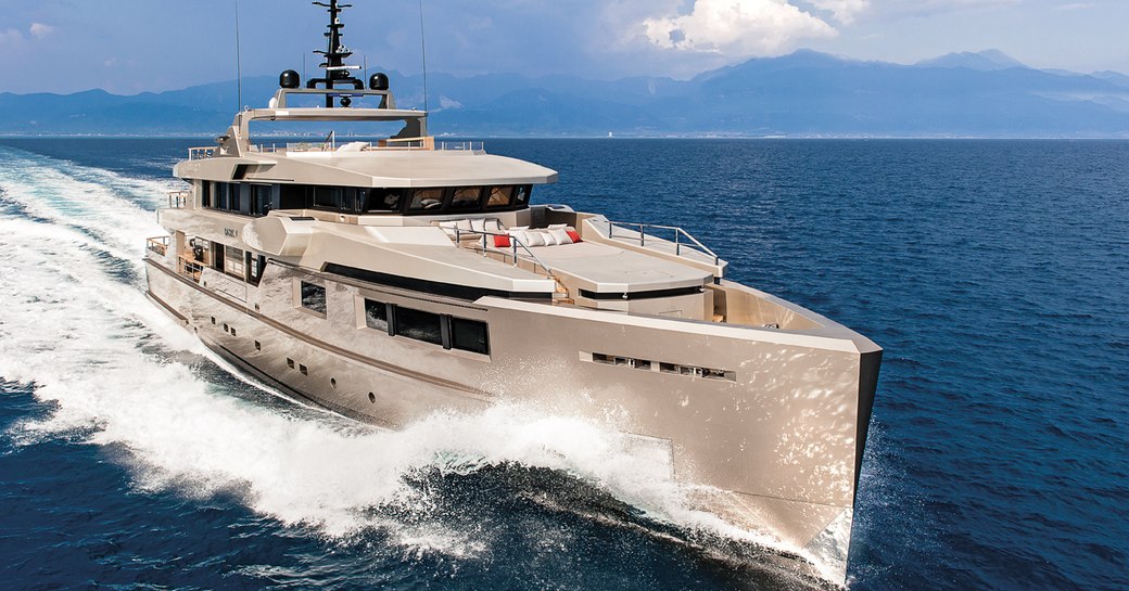 bronze superyacht GIRAUD cuts through the water on a charter vacation