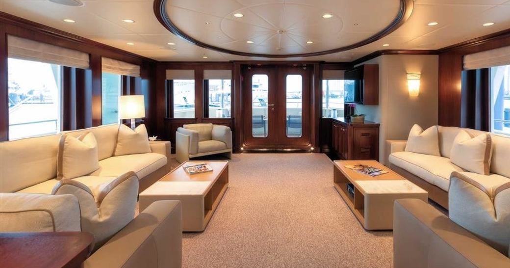 sapele main salon with two large sofas and armchairs aboard expedition yacht SAFIRA 