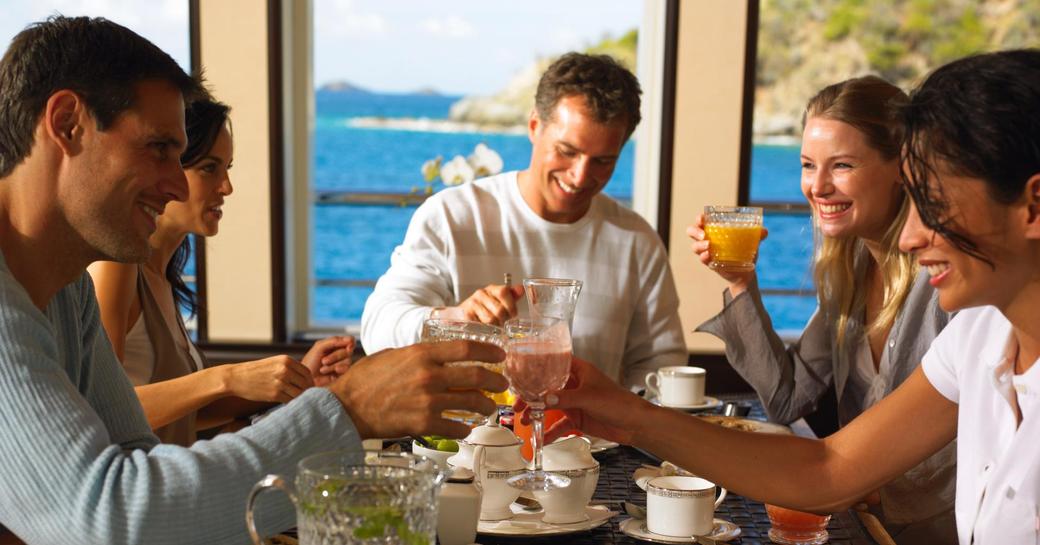 charter guests enjoy breakfast in the upper deck dining area on board superyacht HARLE 