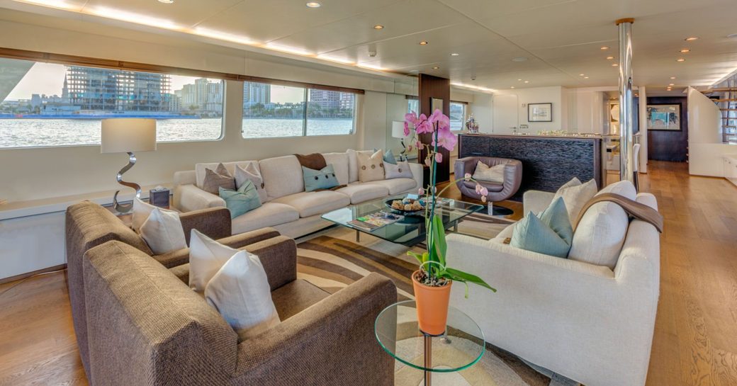 sofas and armchairs create a sociable seating area in the main salon aboard luxury yacht LIONSHARE