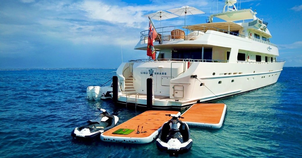 Aft of superyacht LIONSHARE with two tenders and swimming platform in view