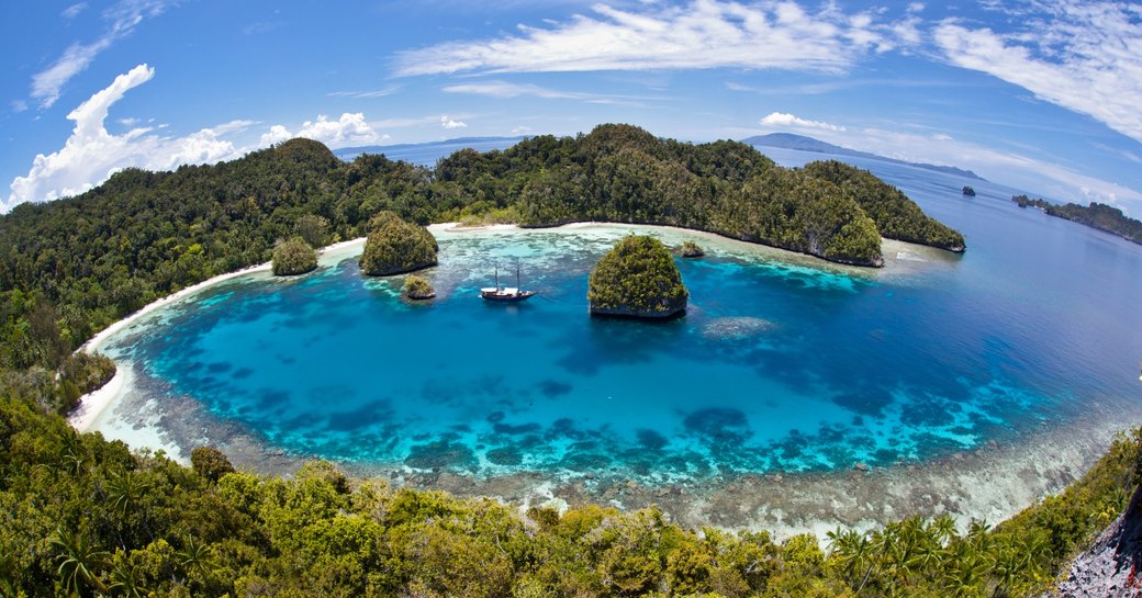 Coral islands and pristine blue waters of Raja Ampat in Indonesia