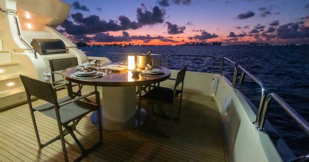 Laid table in open air on deck of charter yacht NOMADA 