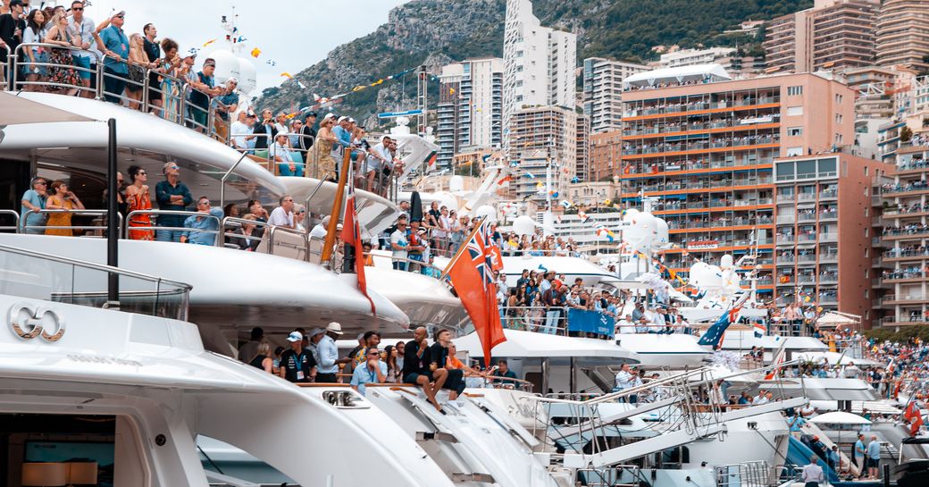 Crowds cheer from the aft of the yachts lined up in Port Hercules at the Monaco Grand Prix