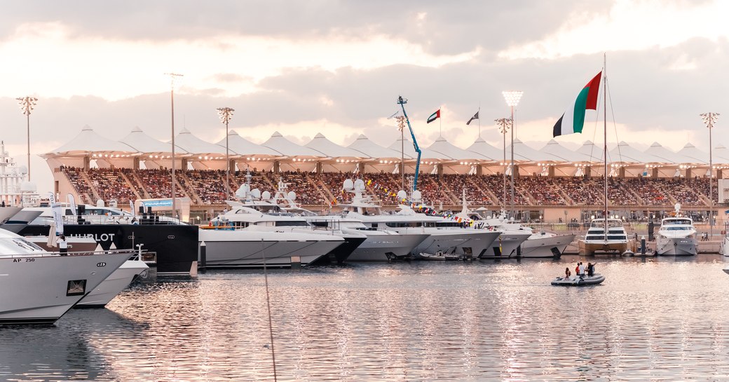 superyachts berth in Yas Marina with grandstand in the background for the Abu Dhabi Grand Prix