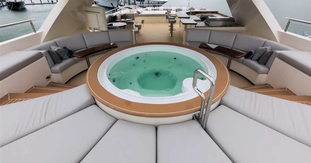 spa pool surrounded by sunpads and cocktail tables on the sundeck of expedition yacht SAFIRA 