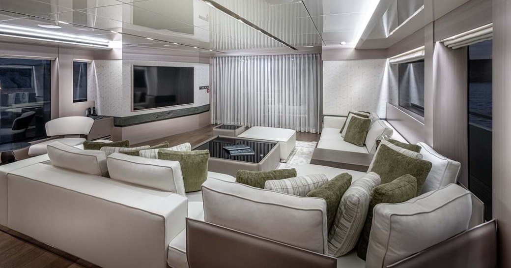 Main saloon area with comfortable sofas facing large TV on explorer yacht 'Seven Diamonds'