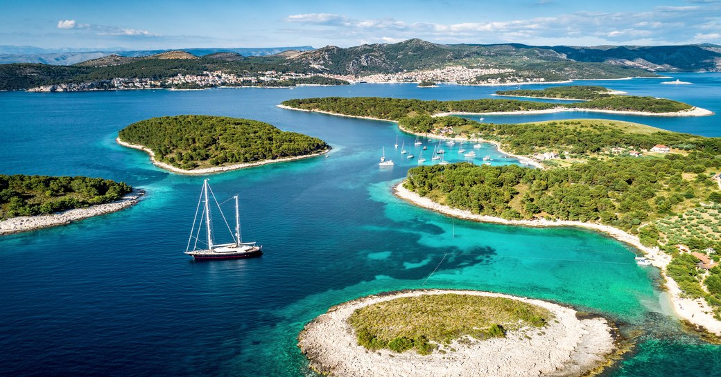 A lone sailing yacht anchored among Croatia's islets