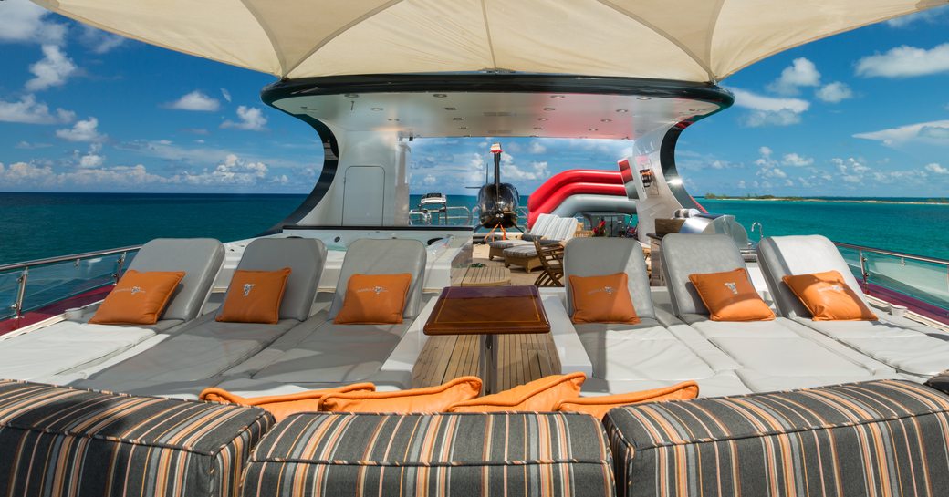 loungers line up under Bimini shade on the sundeck of luxury yacht Amarula Sun  