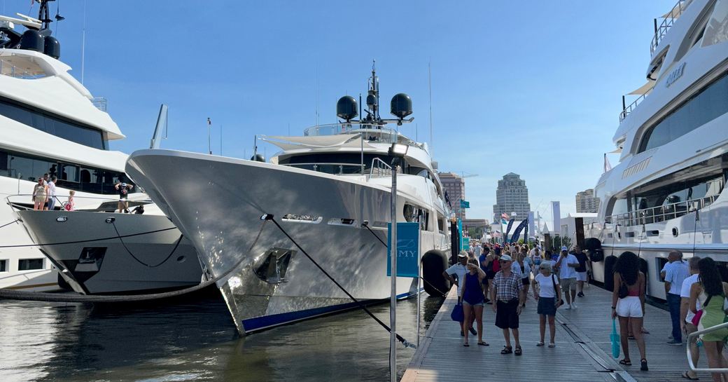 Motor yacht charters berthed with visitors walking by