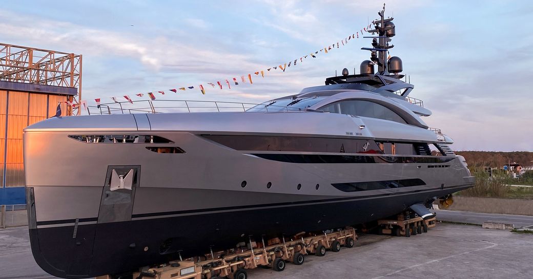 Frontal view image of M/Y NO STRESS TWO sitting on the dock outside construction sheds.