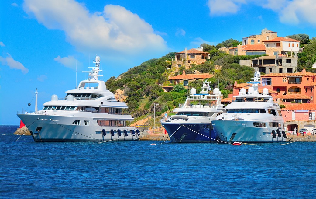 Superyacht charters at anchor by the island of Sardinia