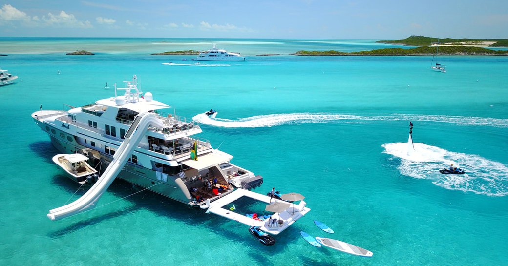 charter superyacht loon in the blue waters of the exumas practising social distancing