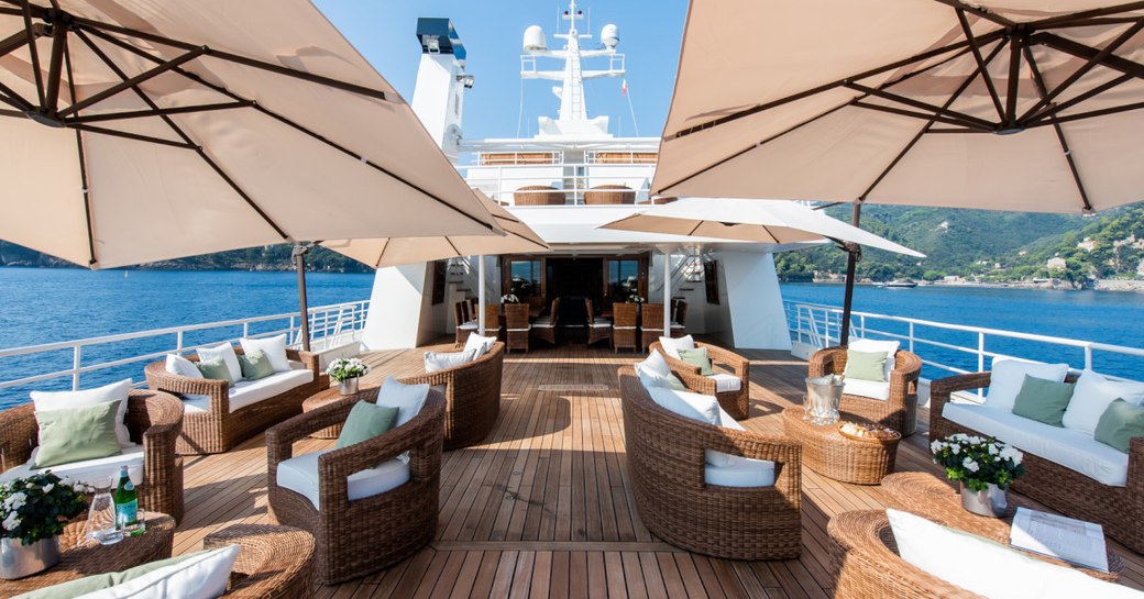 Seating and tables on deck of superyacht Bleu De Nimes