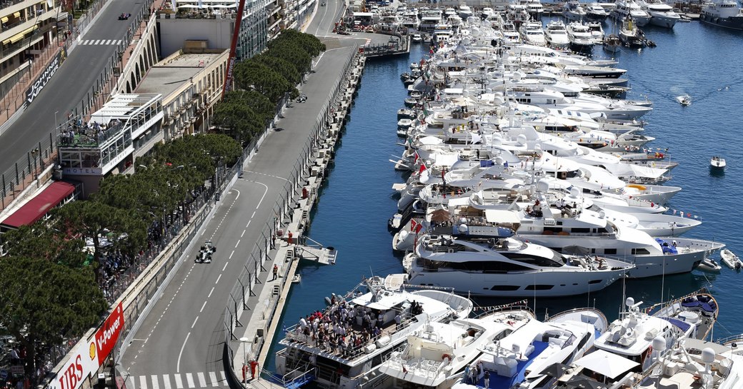 Monaco Grand Prix track curves round Port Hercules which is lined with superyachts