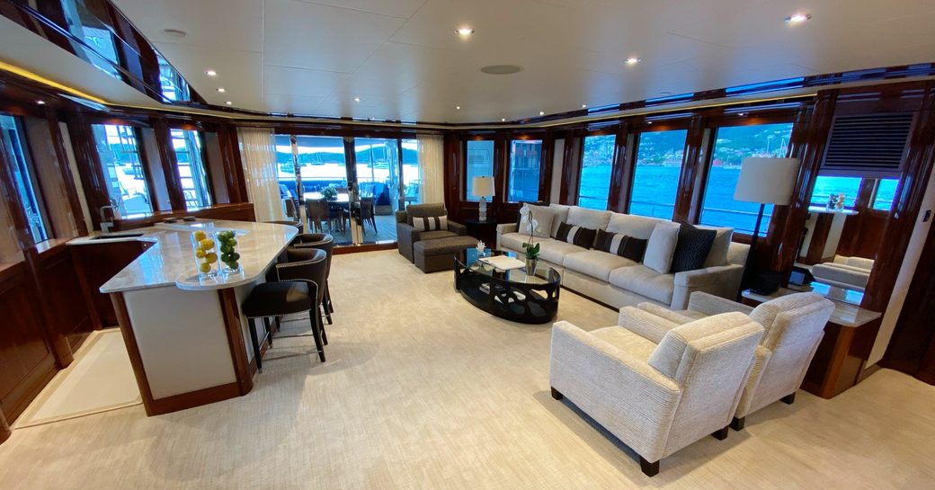 Sofas, armchairs and bar area in interior on superyacht Chasing Daylight
