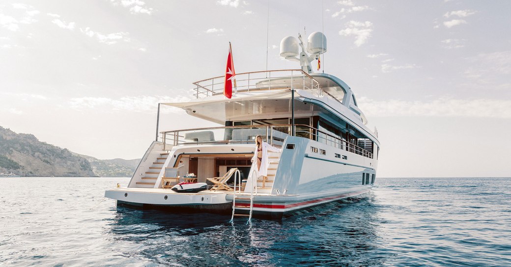 charter guest in the beach club with its drop-down swim platform on board superyacht CALYPSO