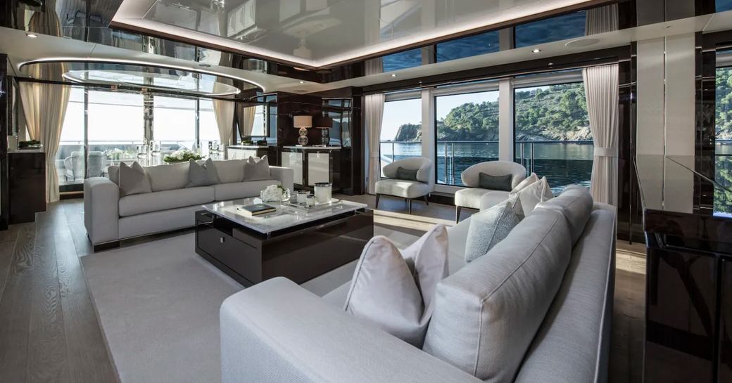 two sofas and arm chairs in the main salon on board superyacht Berco Voyager