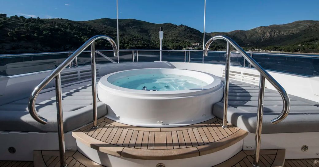 spa pool surrounded by sun pads on the sundeck of superyacht Berco Voyager