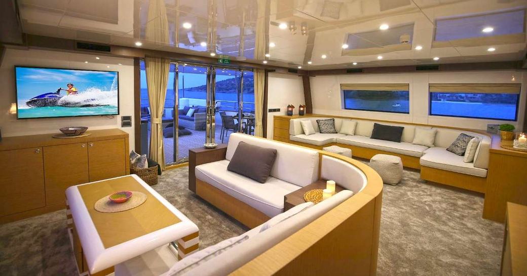 Brightly lit interior on Superyacht Ottawa IV with two large sofas and flat screen TV