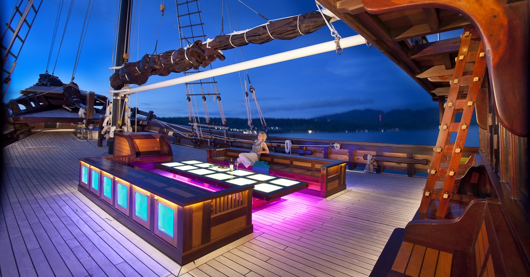 spacious foredeck with lit-up cocktail area on board luxury yacht Dunia Baru’ 