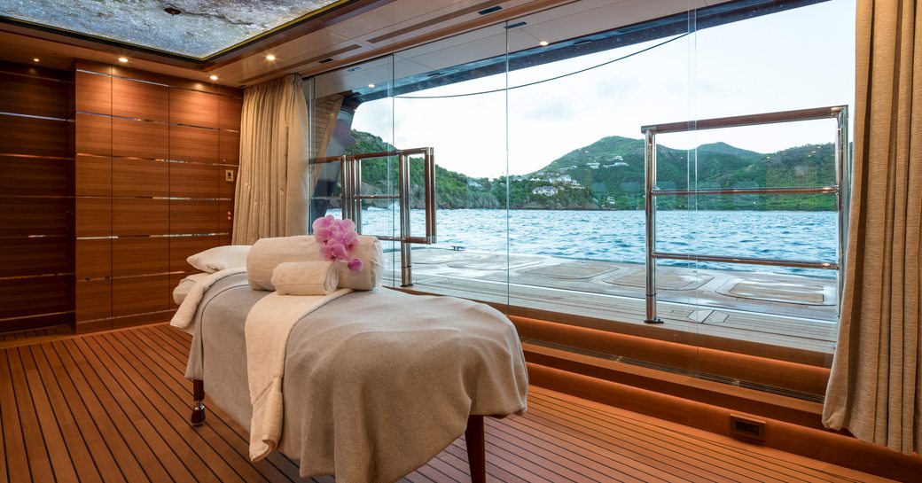 Massage room and table with unfolded balcony adjacent onboard charter yacht BLACK PEARL
