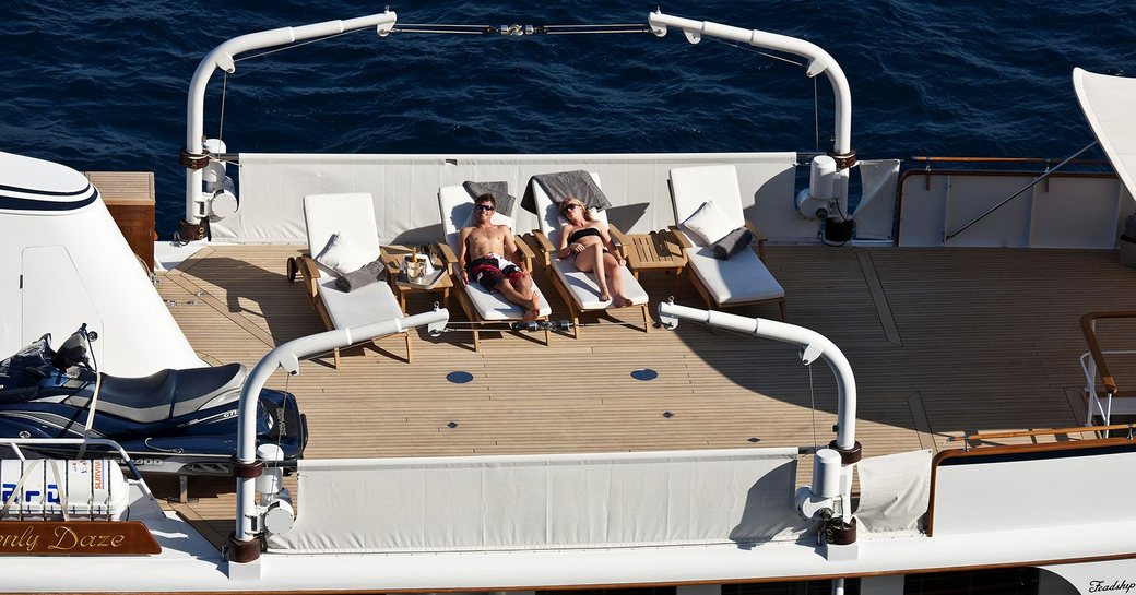 guests relax on the vast sundeck aboard classic yacht ‘Heavenly Daze’