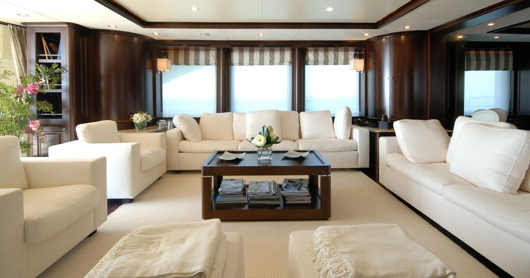 elegant main salon lounge with dark woods and light upholstery on board superyacht ‘Elena Nueve’ 