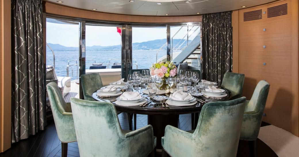 formal dining area in the main salon aft on board charter yacht Midnight Sun