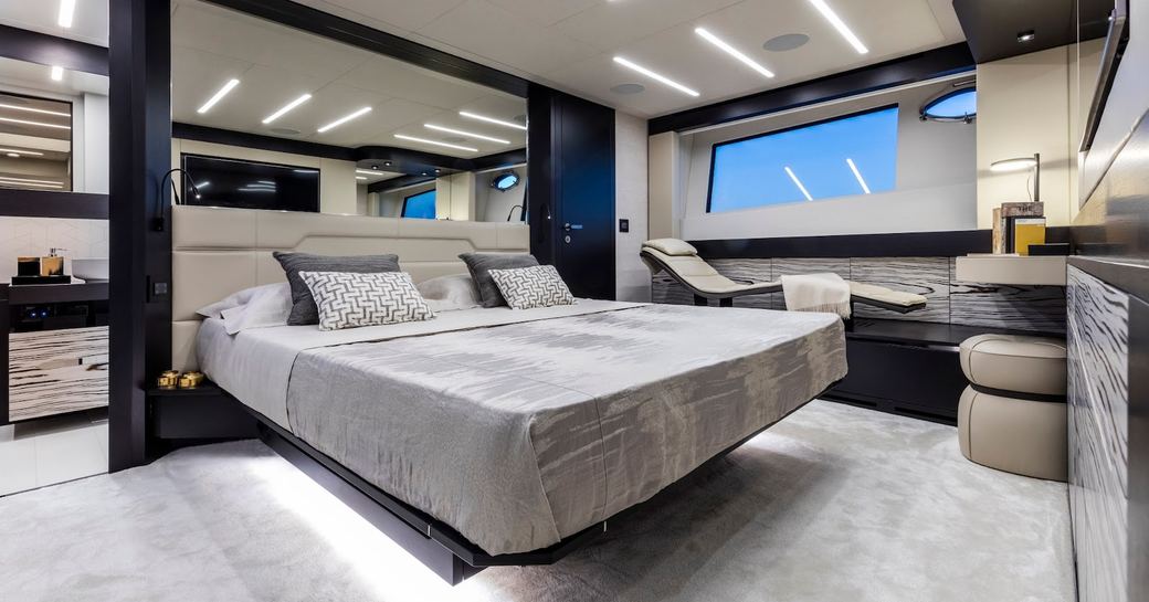 Large cabin on motor yacht BEYOND, with bed and mirror behind bed