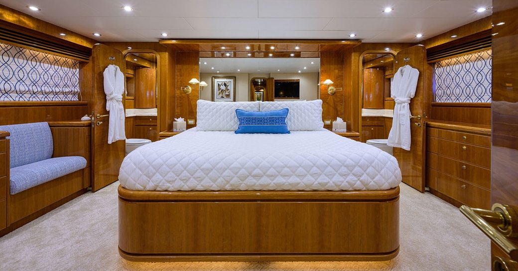 Master cabin onboard charter yacht NEXT CHAPTER, central berth facing forward with seating to port and windows either side of the cabin
