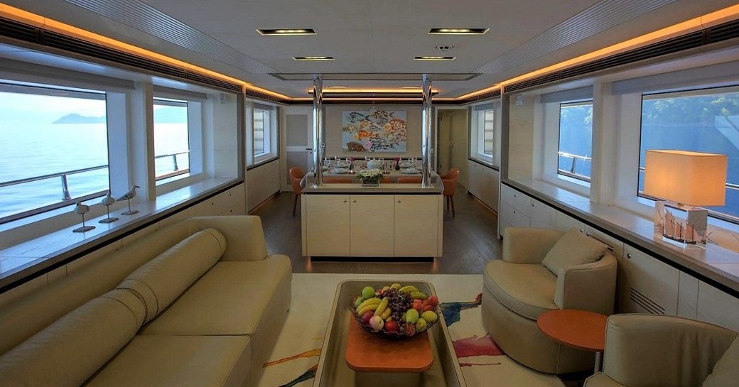 sofa and arm chairs in the main salon's lounge area aboard charter yacht ARCHSEA 