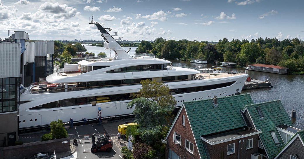 Side angle view of Feadship 'Project 822' leaving her construction shed for the first time.