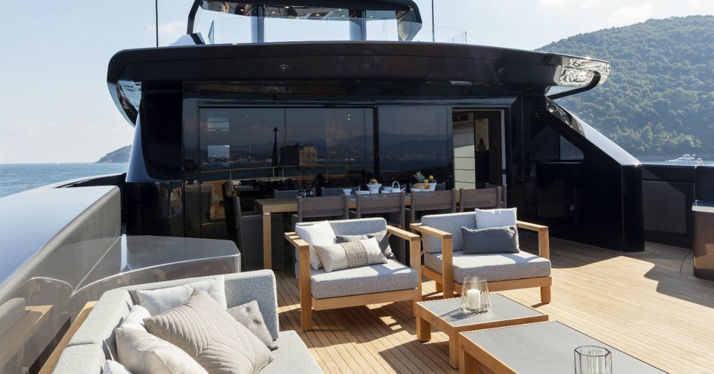 large alfresco lounge and dining area on the upper deck aft of superyacht Lucky Me 