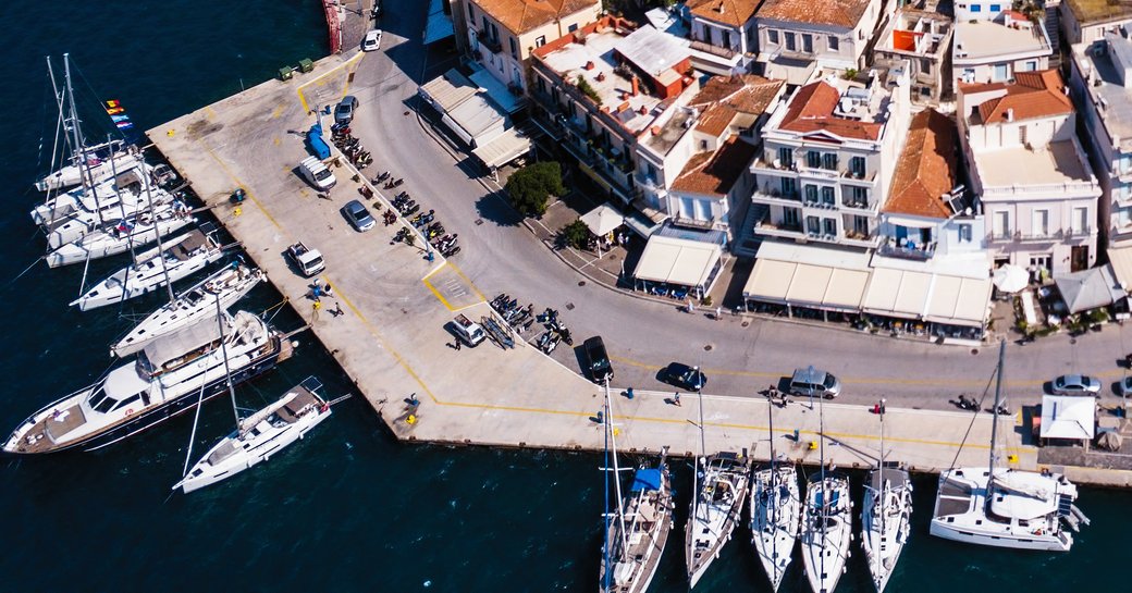 Aerial view looking down on superyacht charters berthed in Poros Port, Greece