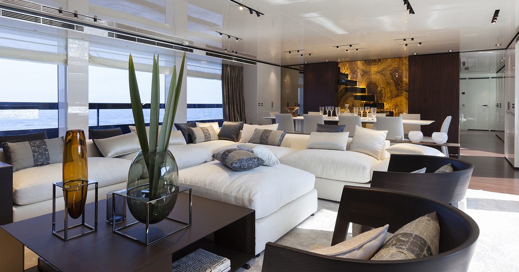 white lacquer, rosewood and jet black accents of the main salon aboard charter yacht Lucky Me 