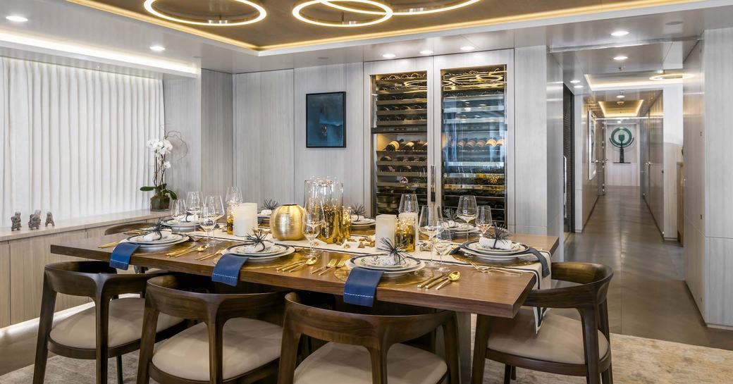 formal dining area in main salon of superyacht BROADWATER with wine cooler