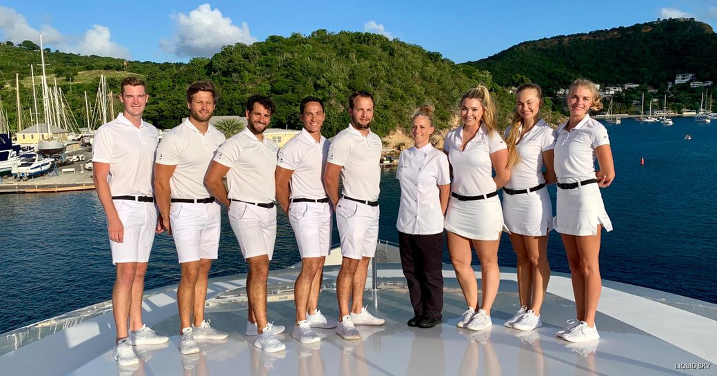 the ready and able crew of a luxury yacht in white unifrom