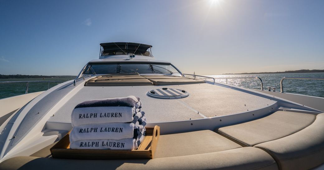 Foredeck sunpad area with Ralph Lauren towels onboard charter yacht CHESS