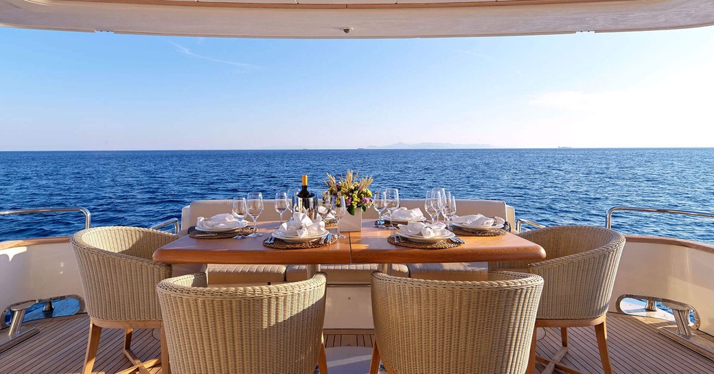 Alfresco dining set up on the aft deck of charter yacht ESSOESS 