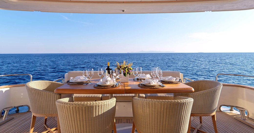 Alfresco dining set up on the aft deck of charter yacht ESSOESS 