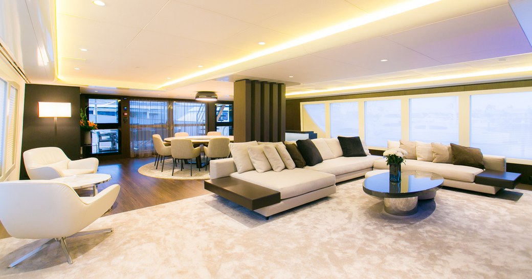 stylish and modern main salon on board motor yacht SAHANA with sumptuous lounge and dining table