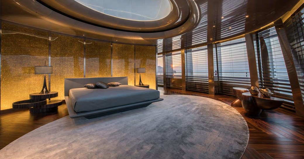 Large bedroom on superyacht SAVANNAH, with lots of open space and windows all around