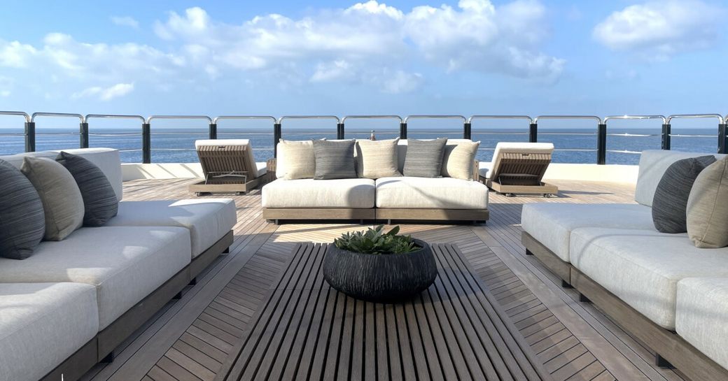 Overview of the aft deck onboard charter yacht ARBEMA, three sofas facing inwards with the sea in the background