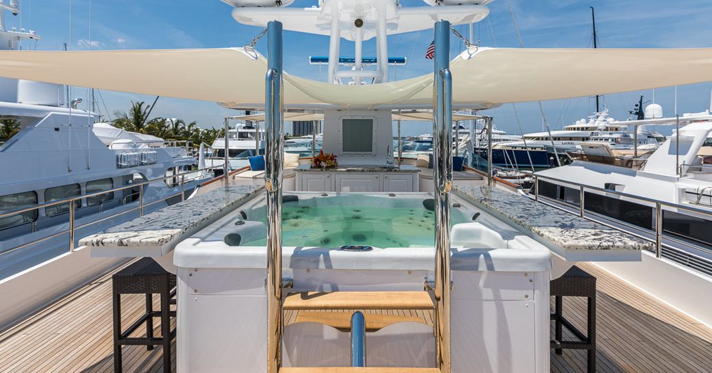 Jacuzzi surrounded by bar on sundeck of superyacht PRAXIS 