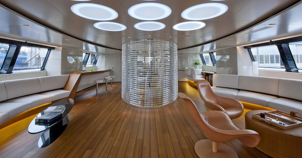 sinuous seating and feature stairwell in the open-plan main salon aboard superyacht PANTHALASSA 