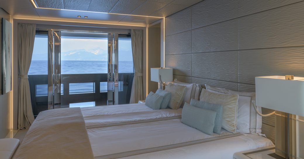 Large cabin on superyacht EIV with view out of balcony in background