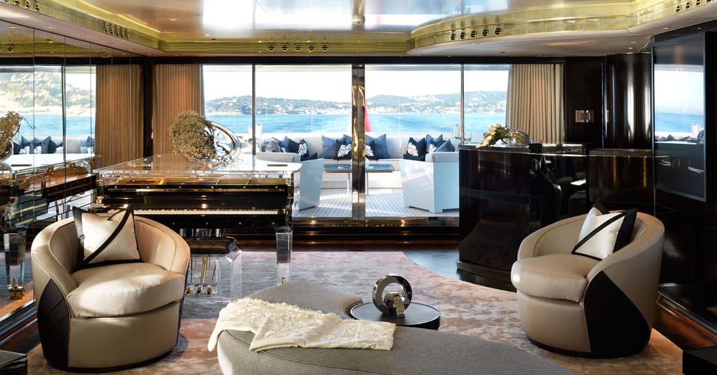 Art deco-themed main salon with bar and piano on board motor yacht SEALYON